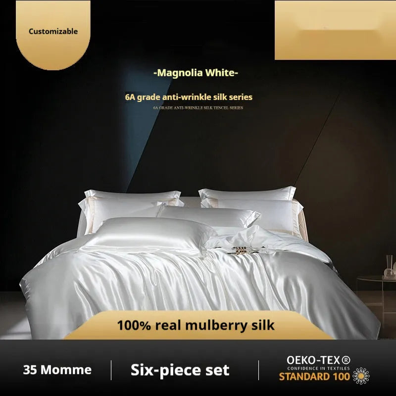 Solid colour silk quilt cover set on a bed in champagne gold, showing flat sheet and pillowcases.