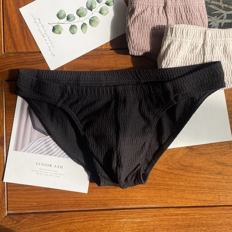 Men's solid colour cotton triangle underwear briefs with mid waistband, shown in apricot black colour.