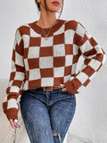 Dark brown plaid loose round neck acrylic pullover sweater on a hanger