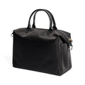Large black nylon waterproof shoulder bag with leather trim on a model