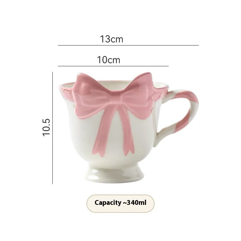 Ceramic mug with heart bow design in Black Pink colour, 301-400ml capacity.