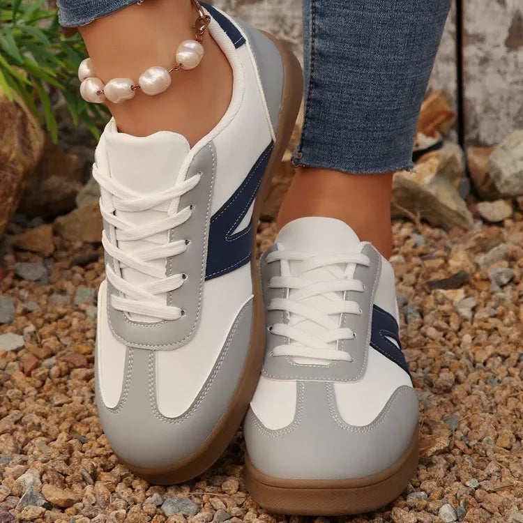 Blue women's flat German training shoes with lace-up front and rubber sole.