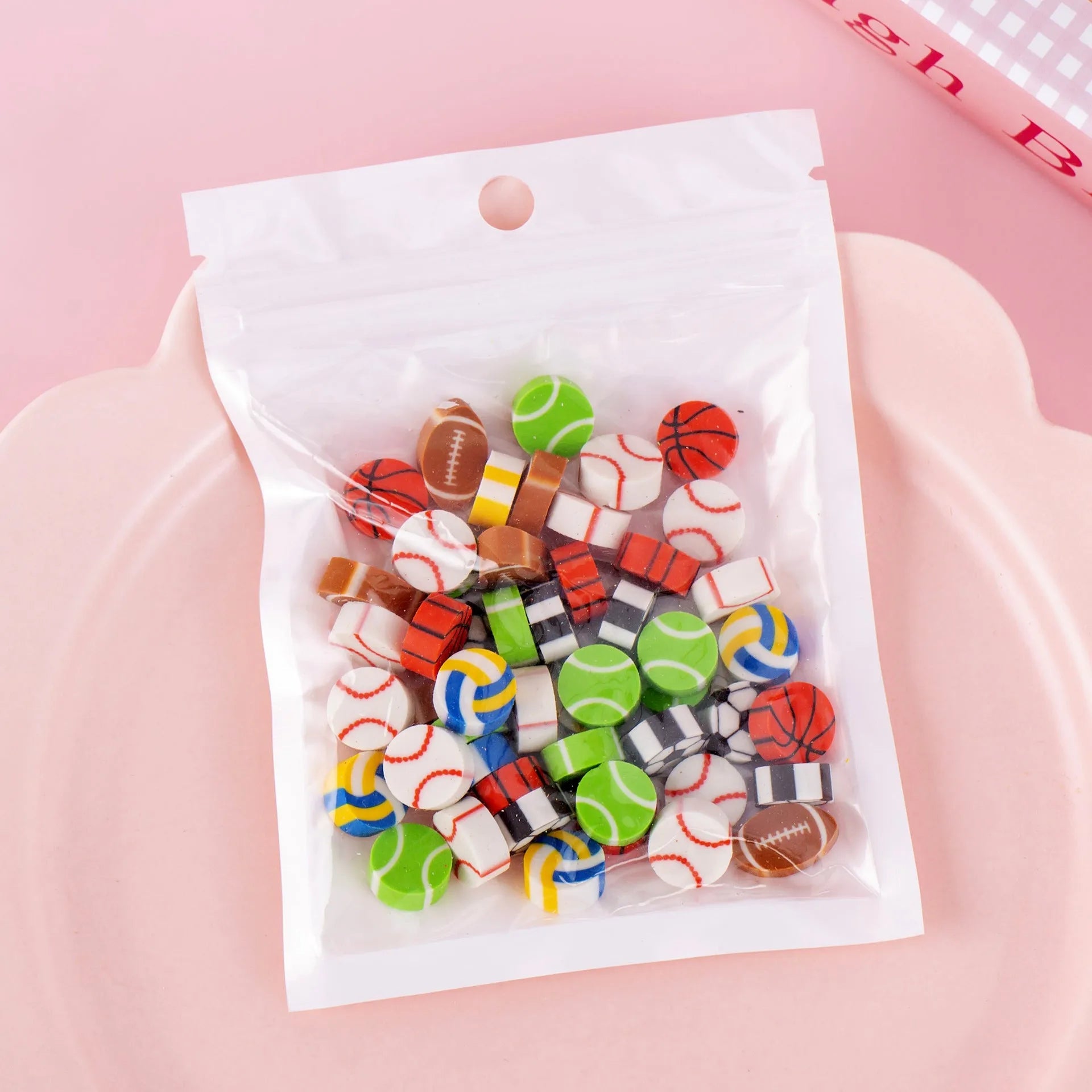 50 colourful cartoon mini erasers in pearlescent bags showing fruit, animal, and holiday designs