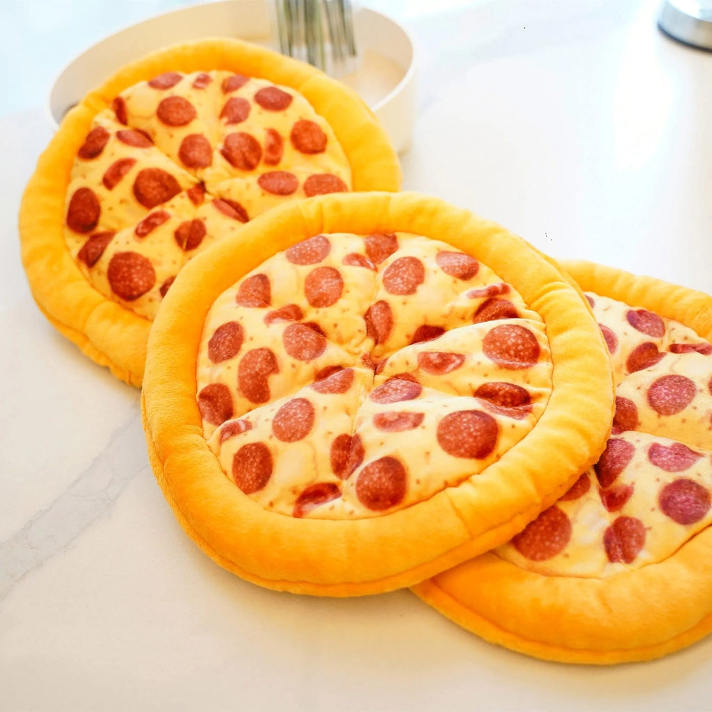 Yellow pizza slice shaped rubber dog chew toy with textured ridges and a squeaker.
