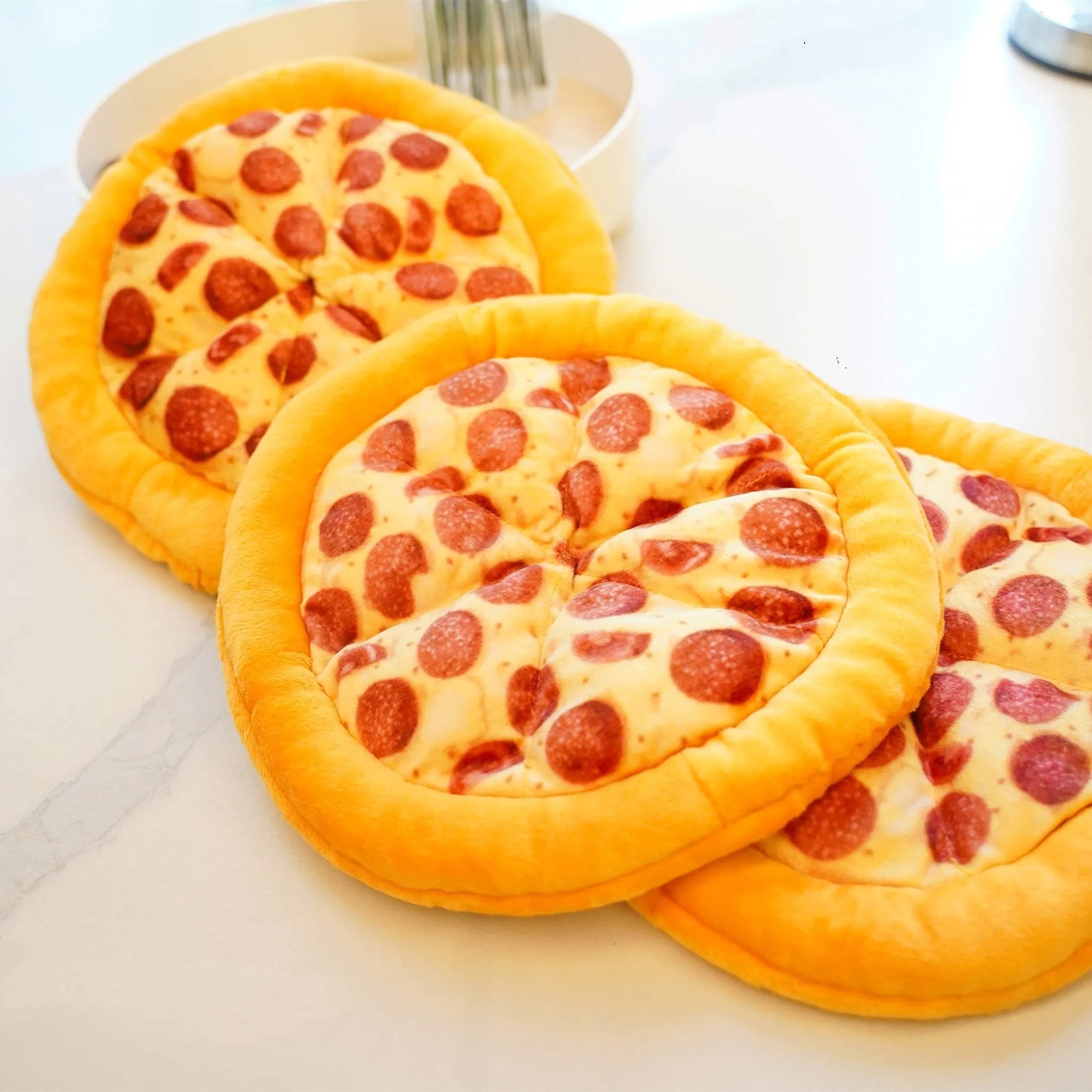 Yellow pizza slice shaped rubber dog chew toy with textured ridges and a squeaker.