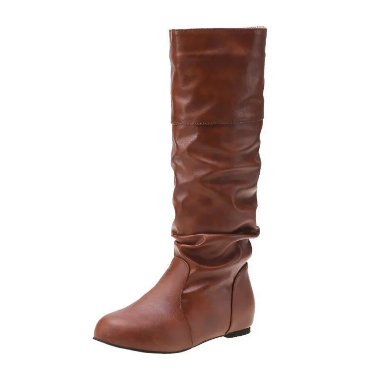 Women's black slip-on flat boots with round toe and high cylinder design on a neutral background.