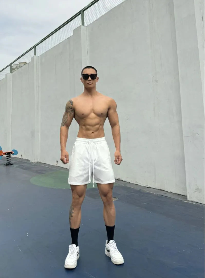 Men's ice silk quick-drying double-layer shorts in light grey, showing casual fit and elastic waistband.
