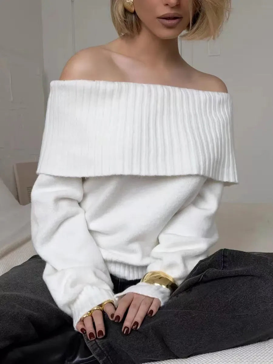 Grey off-the-shoulder sweater with a 3D pattern and strapless design, laid flat.