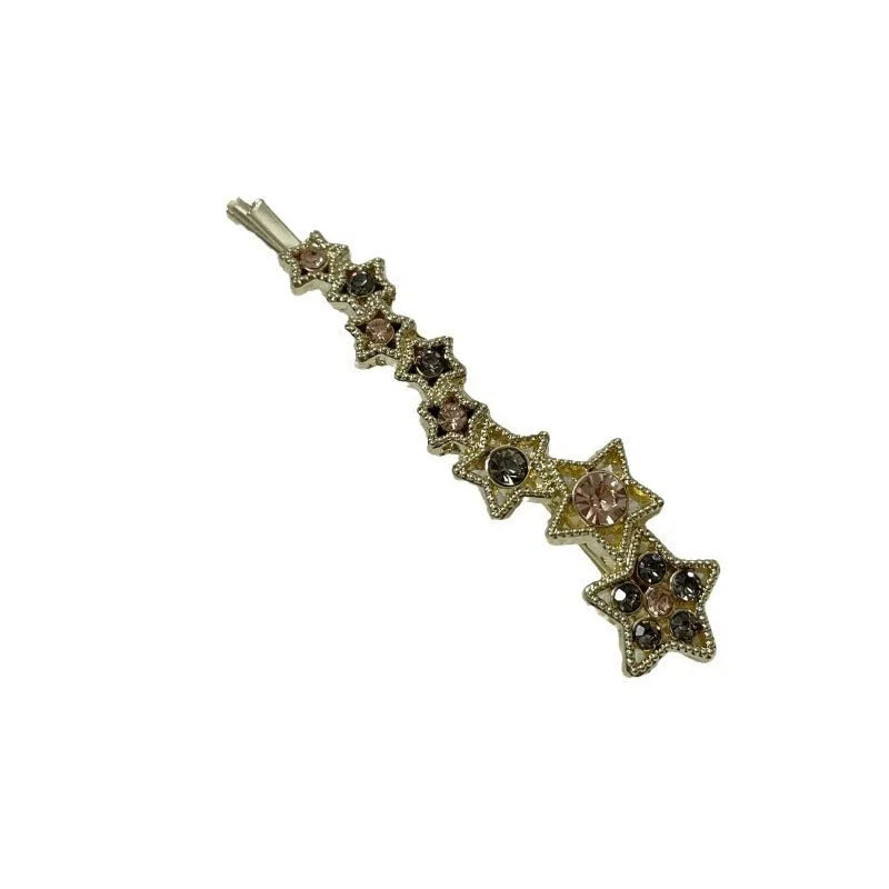 Gold electroplated alloy barrette with five-pointed star rhinestone design and broken clip construction