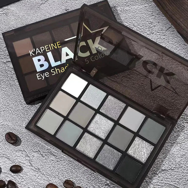 15-colour eyeshadow palette open, showing pans of shimmer, matte, grey, brown, and blue eyeshadows.