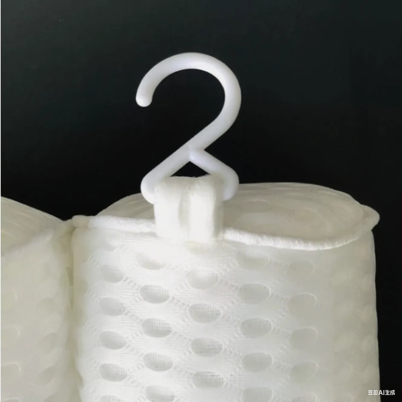 White 4D mesh bathtub pillow with suction cups, shown on bathtub edge.