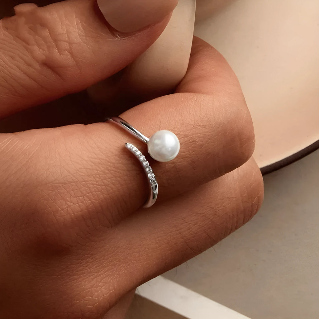 Women's adjustable sterling silver ring with natural pearl on open loop design