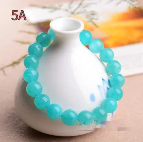 Natural blue-green amazonite scattered beads bracelet on wrist, showing polished stones and single circle design.