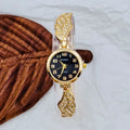 Women's stainless steel fashion watch with round gold dial and vachette clasp.