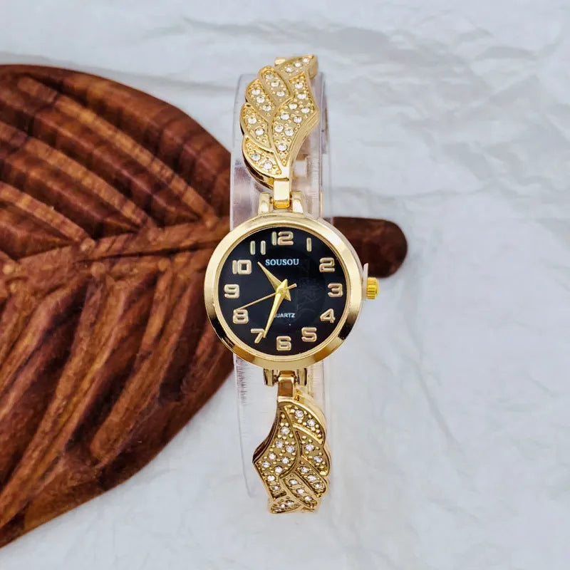 Women's stainless steel fashion watch with round gold dial and vachette clasp.