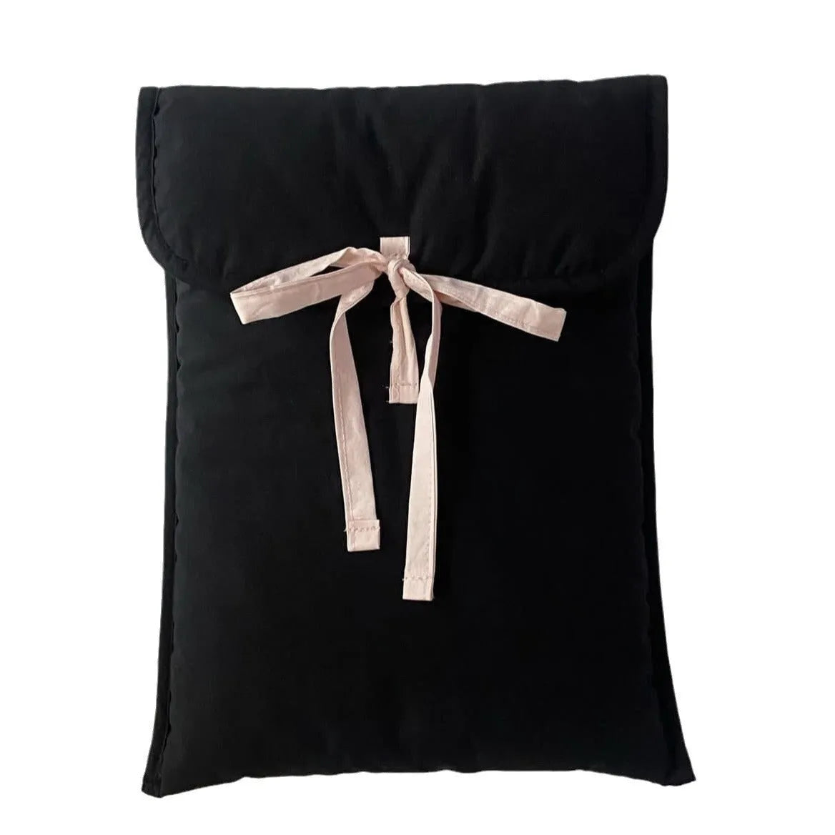 Women's black quilted computer bag with ballet bow detail showing striped nylon lining