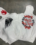 Black hooded sweatshirt cardigan with a white printed skull and rhinestone design on the front.