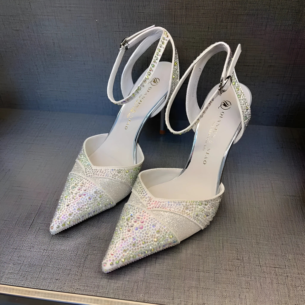 Women's black and silver hollow high heels with red stiletto soles and pointed toes.