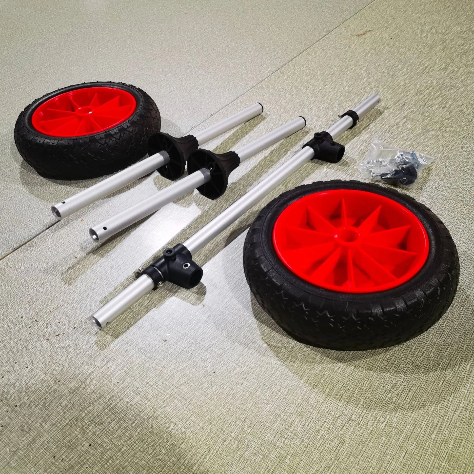 Foldable aluminium kayak beach trailer with upright poles and platform for transporting open kayaks.
