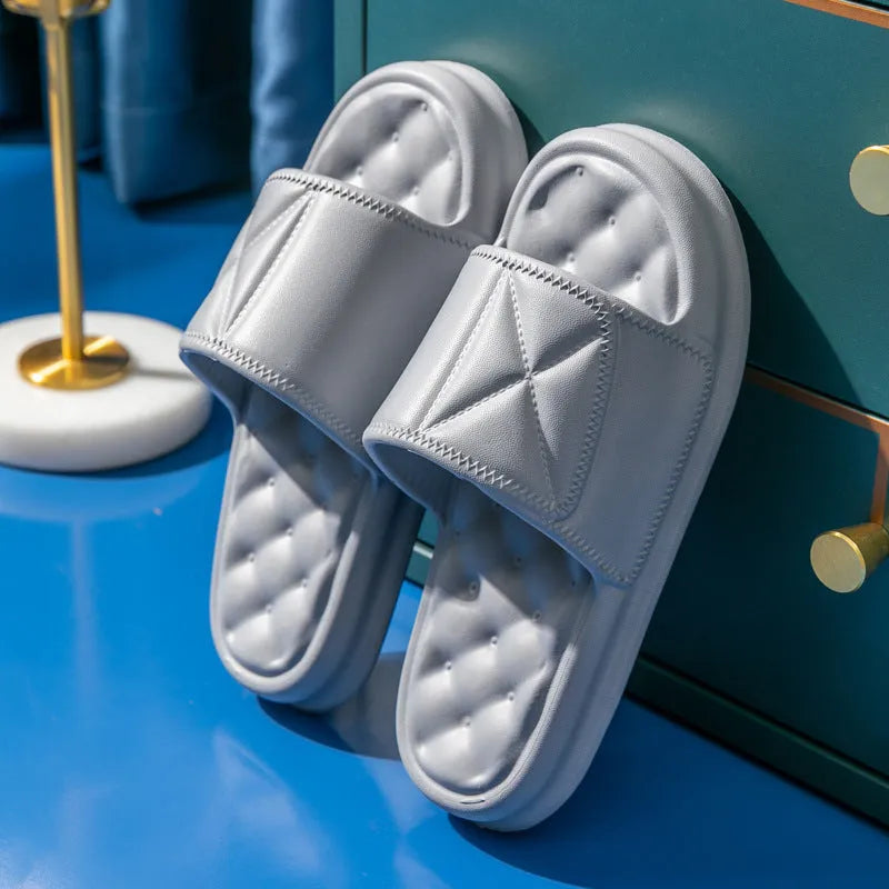 Soft EVA non-slip bathroom slippers with thick sole in assorted colours on a bathroom floor.