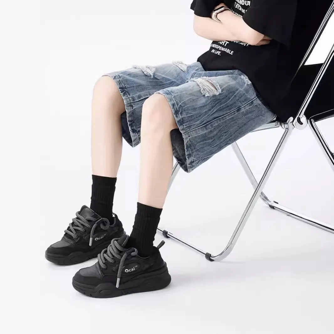 Man's ripped and washed vintage blue denim shorts with a loose, retro fit