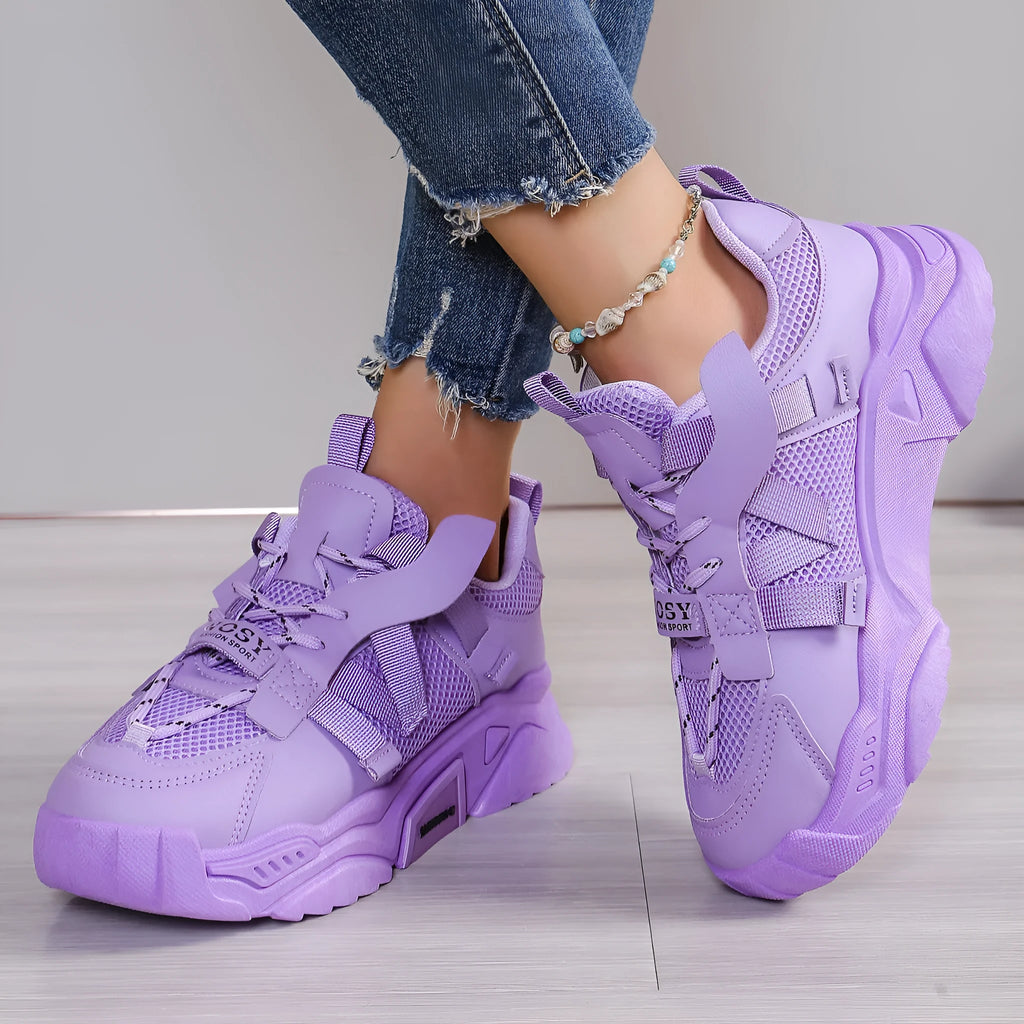 Women's purple platform mesh sports shoe with lace-up front and thick sole for height increase.