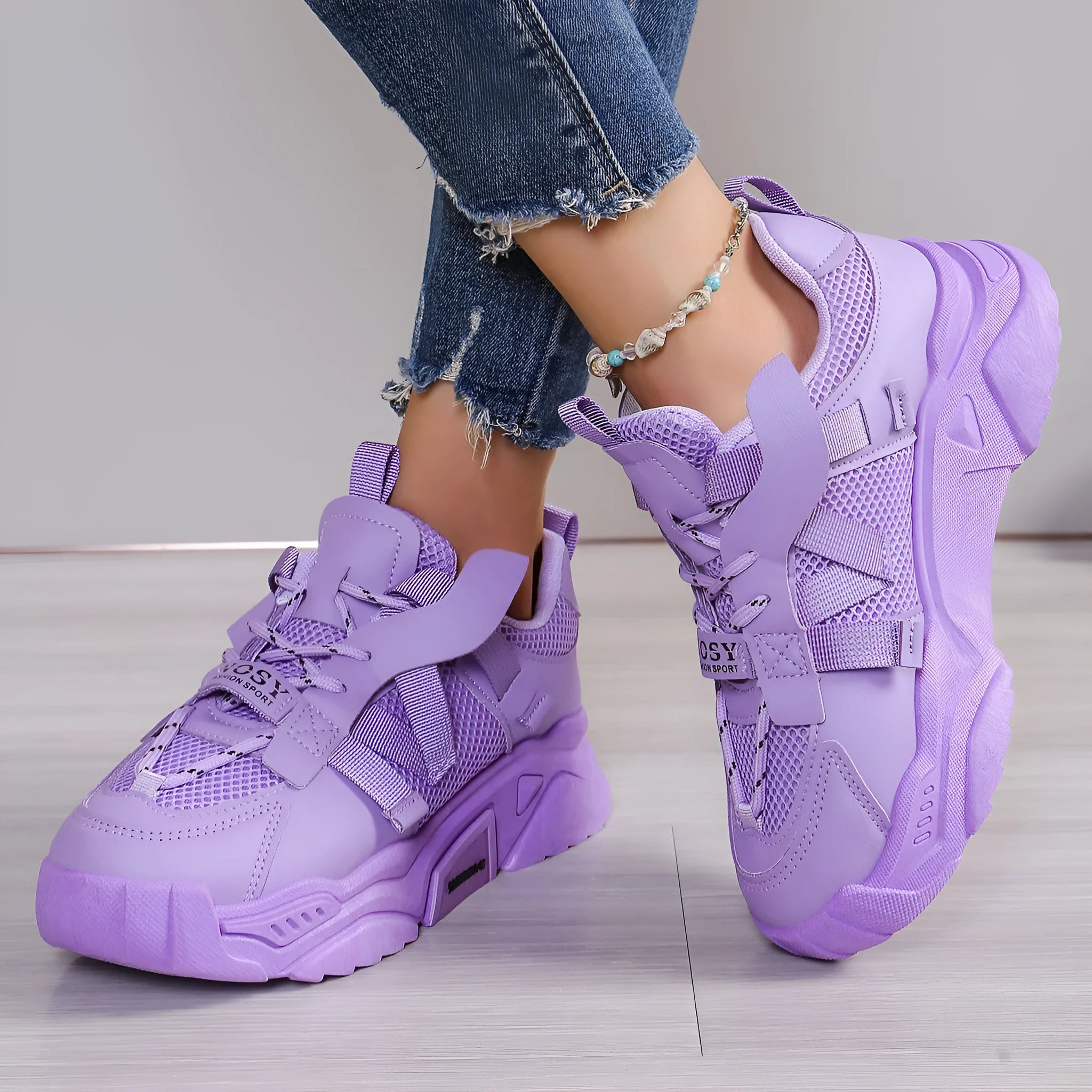 Women's purple platform mesh sports shoe with lace-up front and thick sole for height increase.