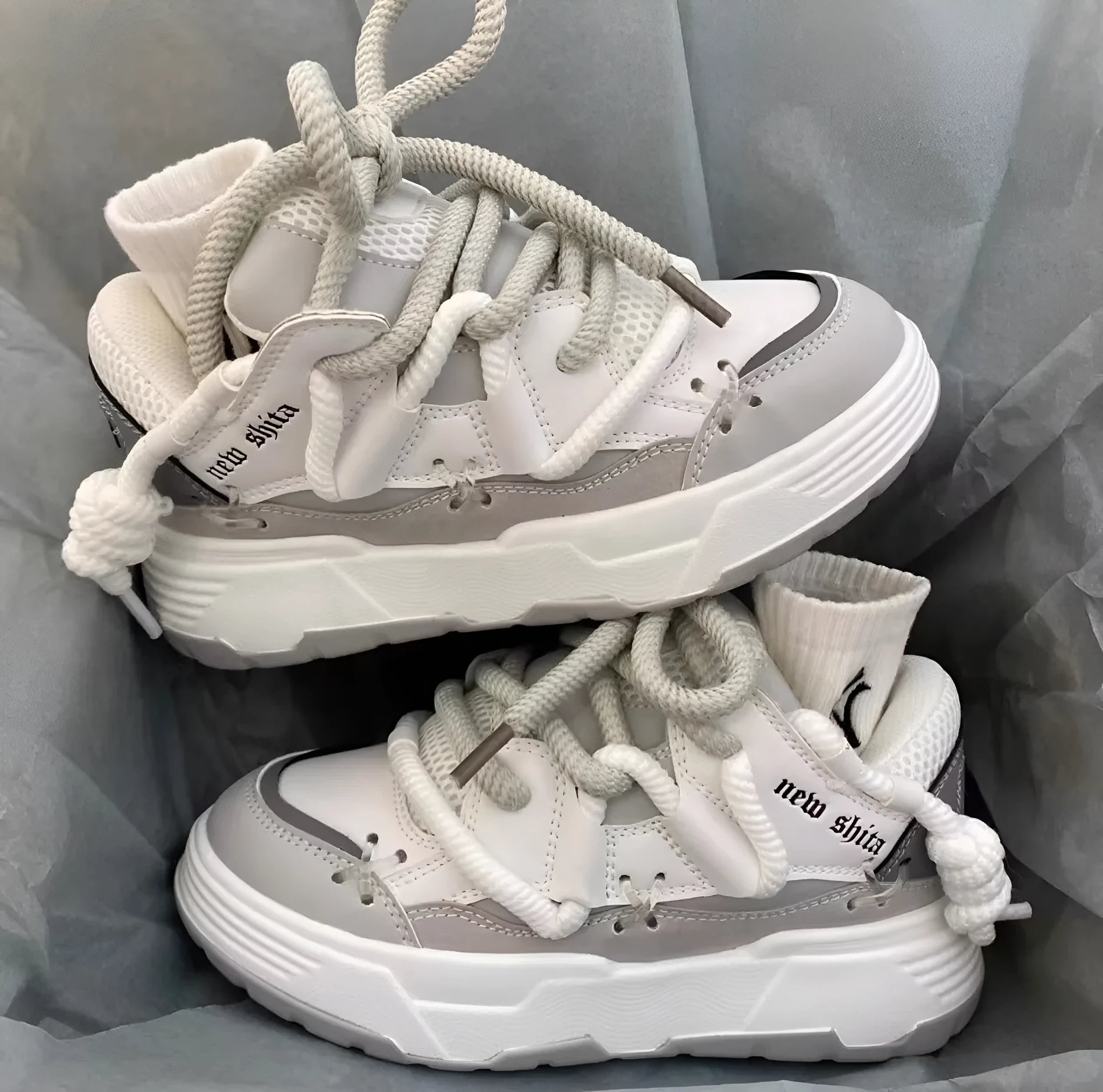 Women's grey retro chunky platform sneakers with thick rubber sole and lace-up front.