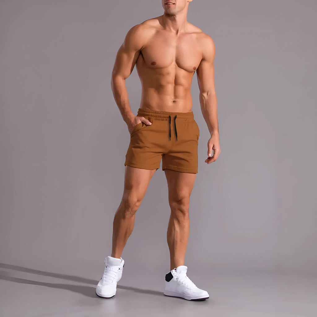 Three pairs of men's solid colour shorts in black, khaki and light brown with drawstring waists