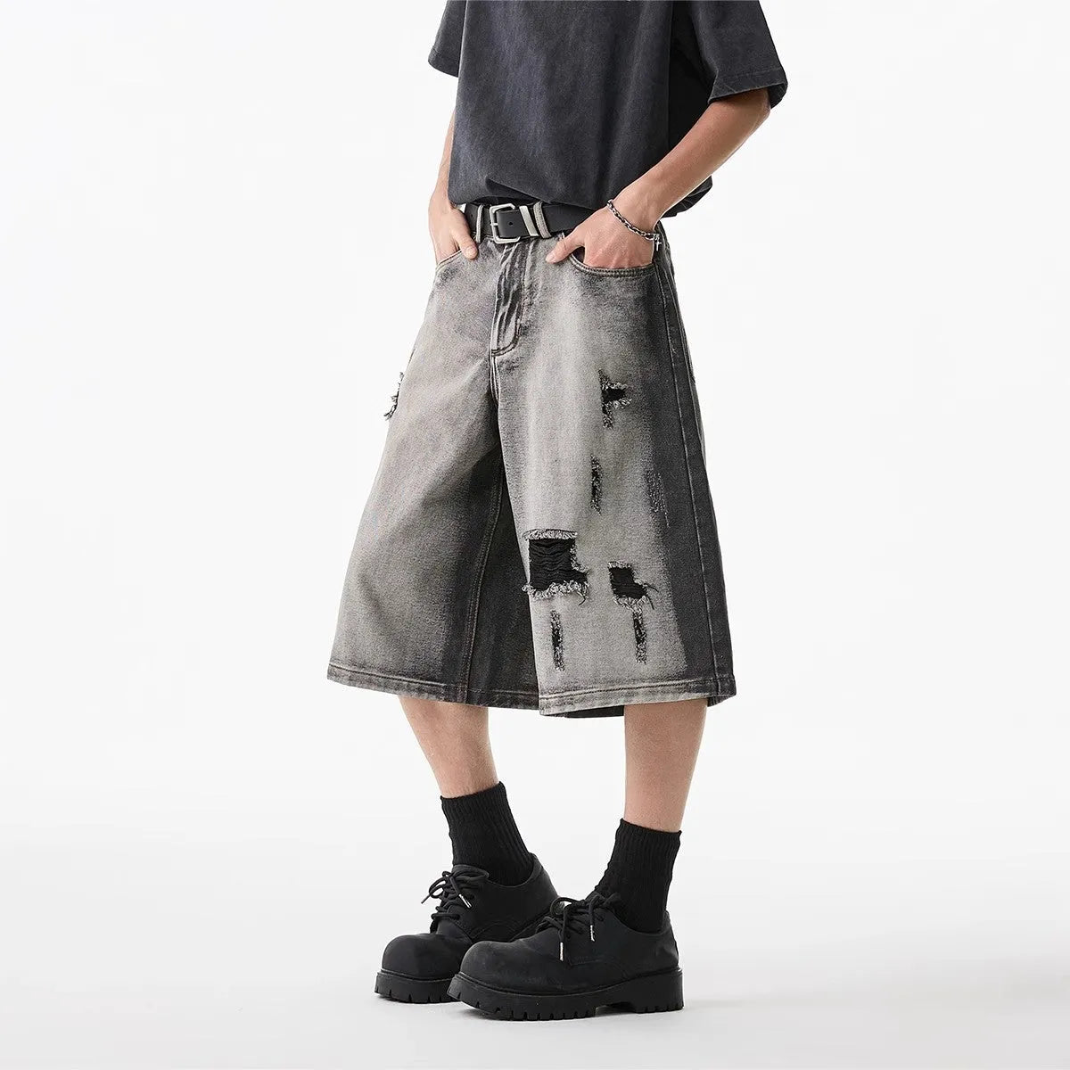 Grey loose-fit denim shorts with a water-washed finish and distressed hole details.