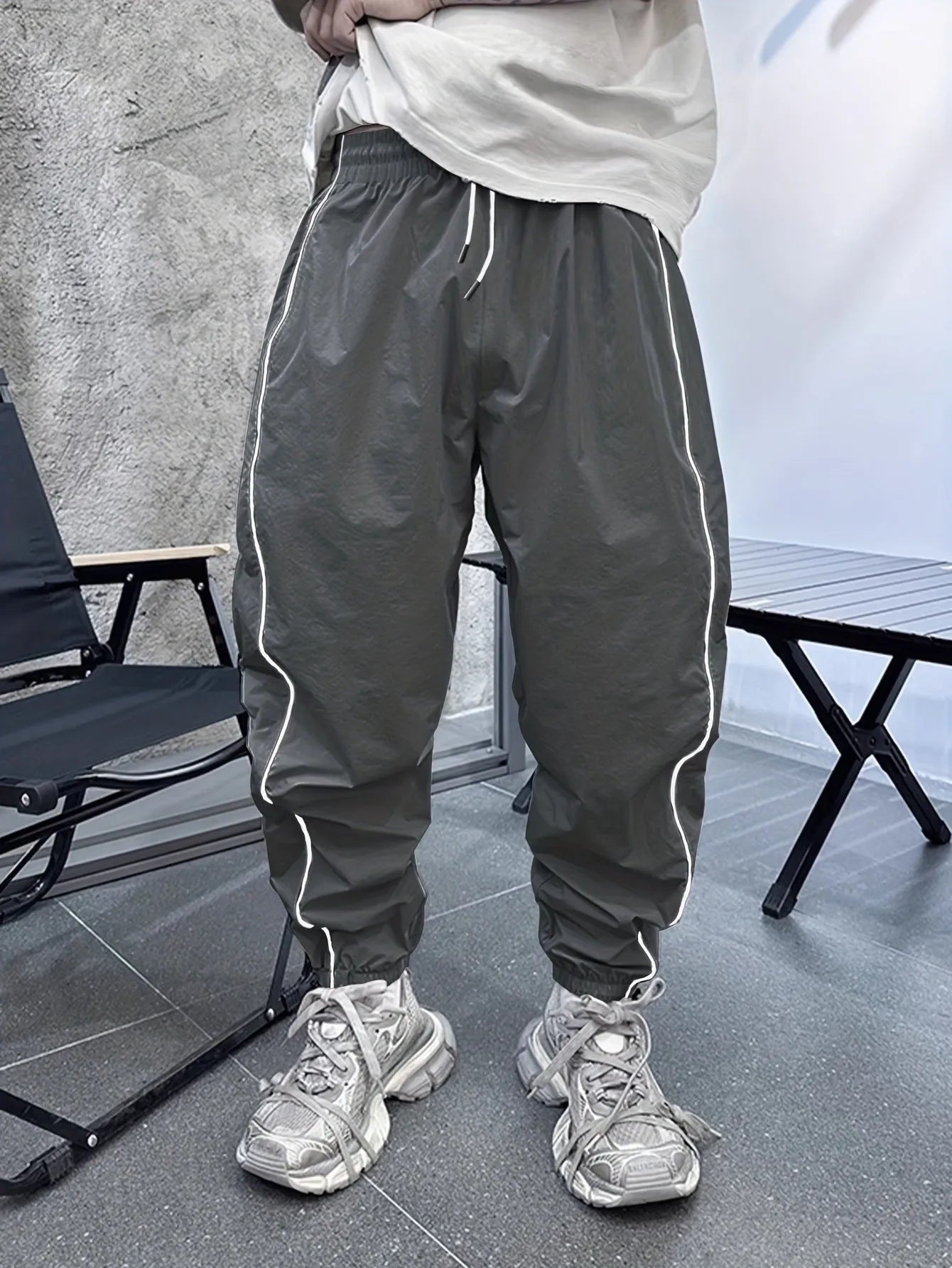 Man wearing blue bamboo fibre casual trousers with a cropped leg and loose fit.