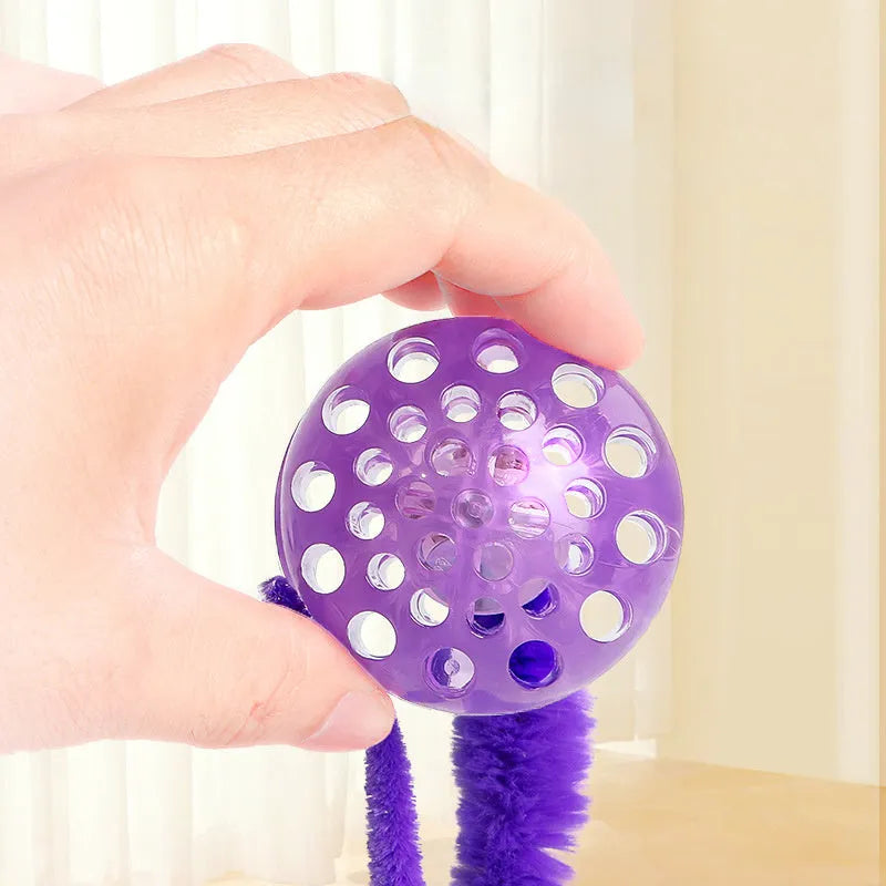 Interactive cat ball toy with worm-like plush tail in green, pink or purple colours