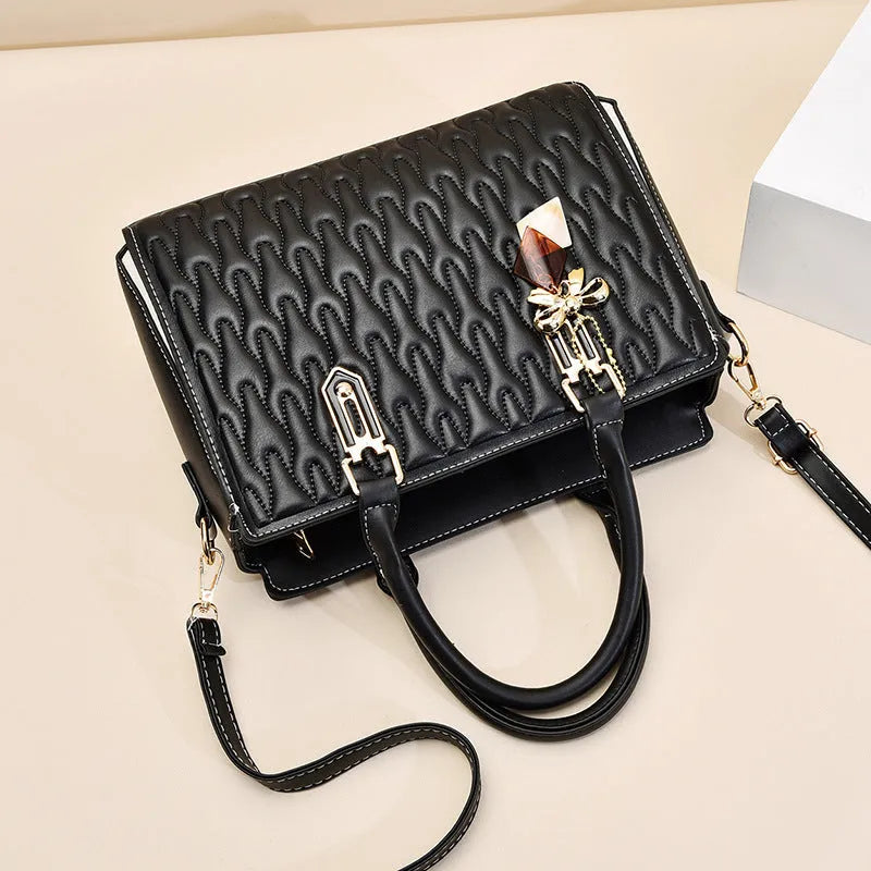 Women's large-capacity polyester messenger bag in black, showing pocket sandwich organisation