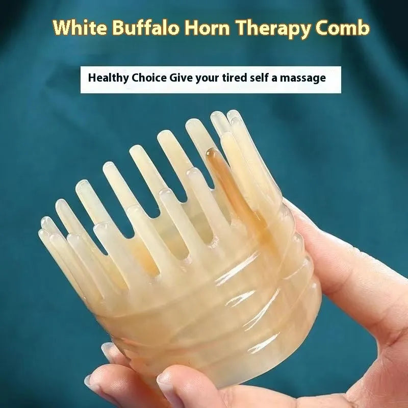 A white buffalo horn comb with wide teeth and a pointed tip for scalp massage.