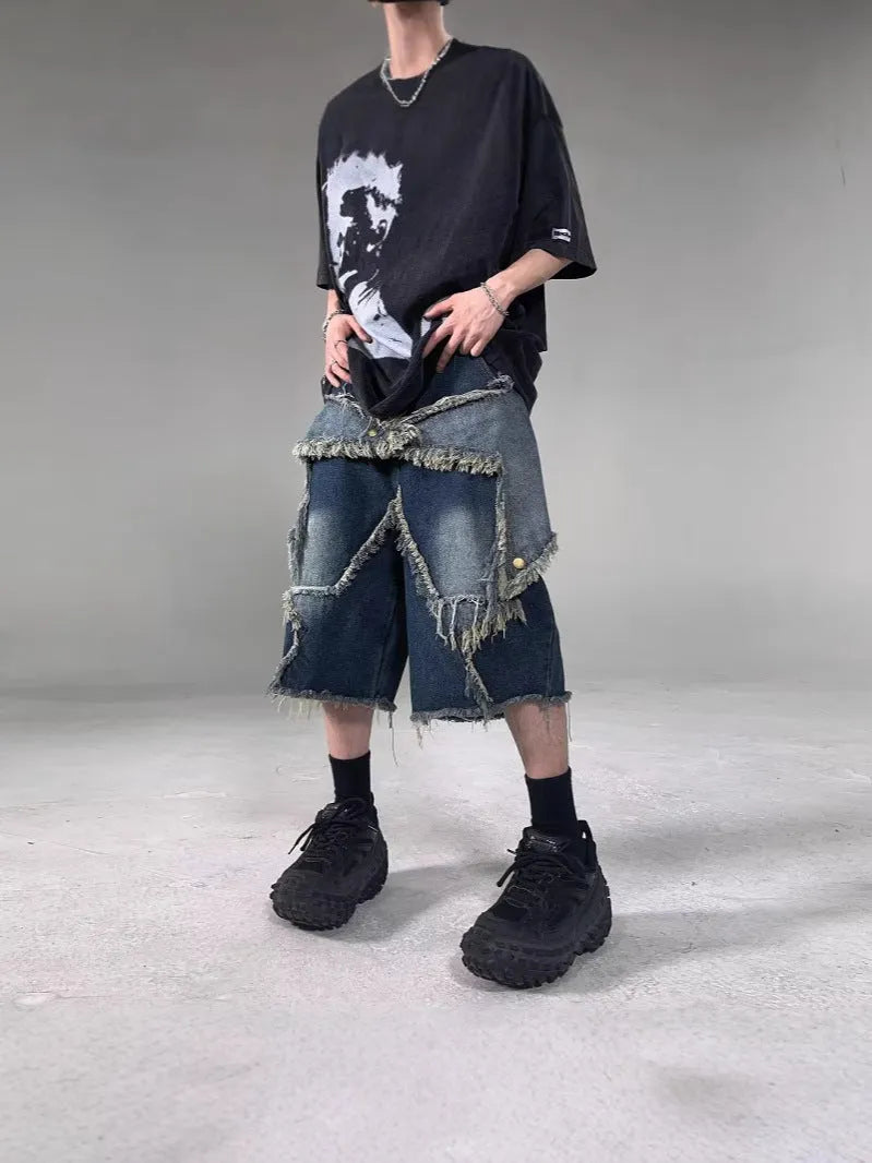 Men's blue distressed denim shorts with a large five-pointed star and frayed hem in a loose cargo fit.