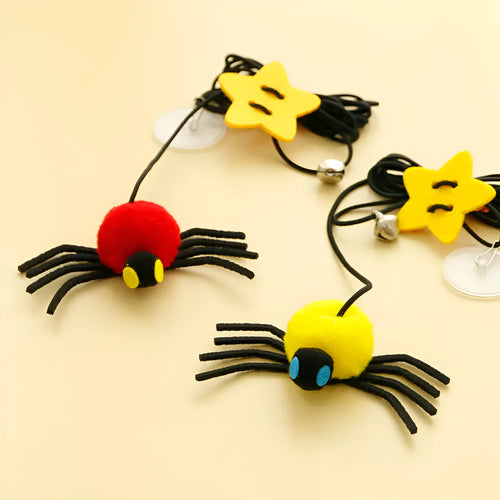 Cat door hanging toy with elastic rope, feather, bell, and spider design in red colour